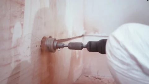 Close-up of drilling a hole in the wall for the socket. High quality 4k footage Stockbeeldmateriaal 153996749