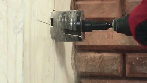Close-up drilling holes in the wall under the socket Stock Footage 148274489