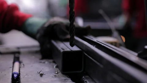 Close up drilling machine drill with holes in metal plate at factory Stock Footage 233392993