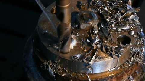 Close-up of drilling machining process in metal part on a lathe, water is Stock Footage 117431030