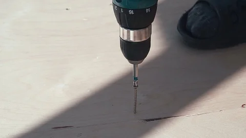 Close up of drilling into wood with screw twisted into place. The screw driver Stock Footage