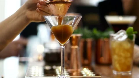 Close Up Of A Drink Being Poured Into In An Isolated Martini Glass Stock Footage 134939779