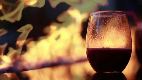 Close up of drink by fire, video Stock Footage 76408318