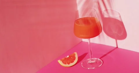 Close up of drink with grapefruit on pink background Stock Footage 341560136