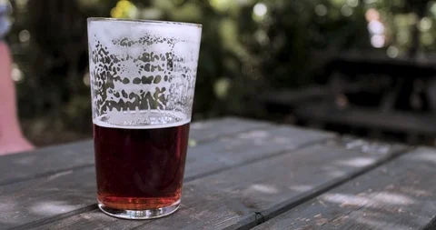 Close up drinking half full pint real ale beer Stock Footage 116043096