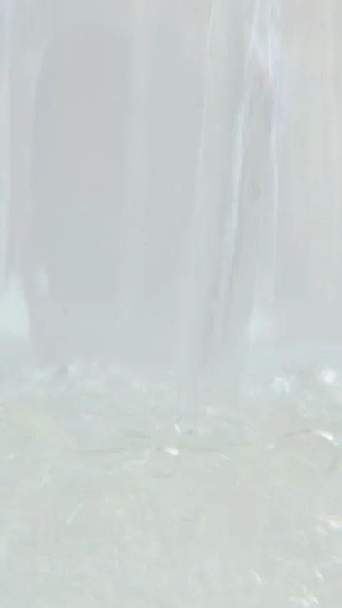 Close-up of drinking water being poured into a glass. Air bubbles in the water. Stock Footage 276412707