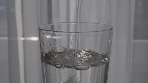 Close-up of drinking water smoothly filling a glass.Healthy lifestyle. Stock Footage 305701957