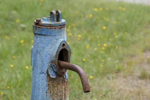Close-up of a drinking water supply column.Old rusty water column in a rural  Stock Photos