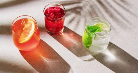 Close up of drinks with orange, raspberry and lemon over shadow Stock Footage 331208174