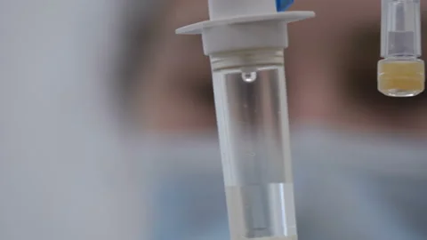 Close-up of drip and face of a nurse in blur Stock-Footage 92108388