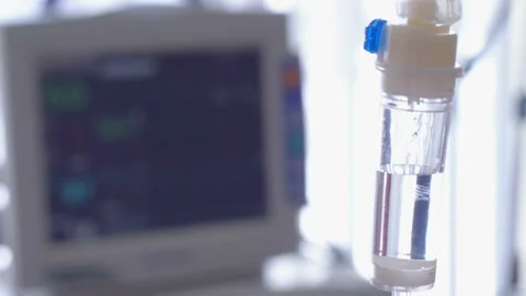 Close up of a drip flask with normal saline dropping in it Stock Footage 88587737