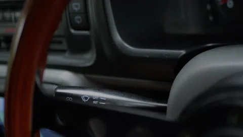 Close-up of driver adjusting windshield wiper control stalk... 動画素材 339101335