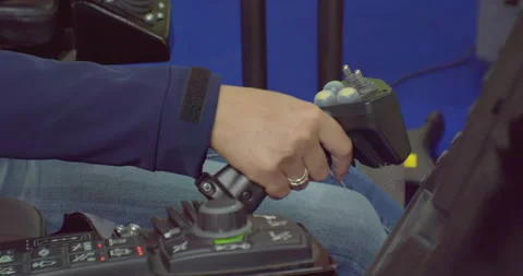 Close-up, the driver controls the car with the joystick.The worker presses the Stock Footage 161478497