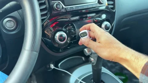 Close Up of Driver Hand Holding Digital Tally Counter Inside Modern Car Interior Stock Footage 331181233