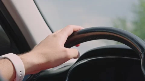 Close Up of Driver Hand Holding Steering Wheel While Driving Car Stock Footage 341765119