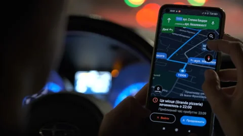Close up of driver hands holding cellphone with Google maps navigation app Stock Footage 167621416