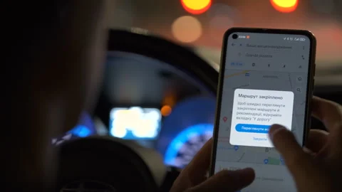 Close up of driver hands holding cellphone with Google maps navigation app Stock Footage 308405974