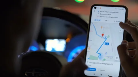 Close up of driver hands holding cellphone with Google maps navigation app Stock Footage 309150522