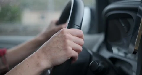 Close-up of driver hands holding steering wheel driving car Stock Footage 321348483