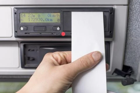 Close up of a driver holding empty printed day shift in focus against a digital Stock Photos