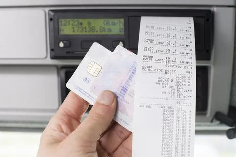 Close up of a driver holding printed day shift in focus together with drivers Stock Photos