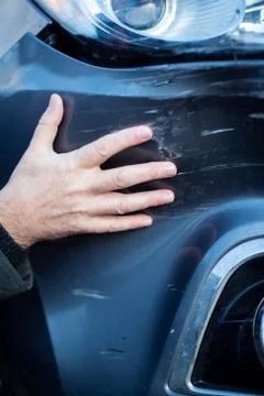 Close Up Of Driver Inspecting Damage To Car After Accident Stock Photos