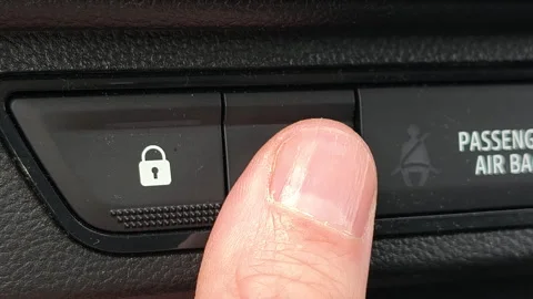 Close up of driver pressing hazard warning button in car Stockbeeldmateriaal 333307117