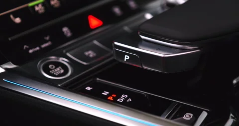 Close-up of a driver pushing the park button on a modern automatic transmission 動画素材 337128376