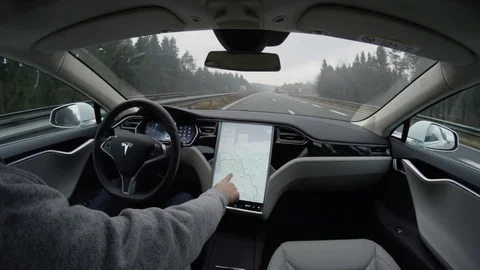 CLOSE UP Driver swiping through touchscreen in self-driving Tesla autonomous car Stock Footage 72835970