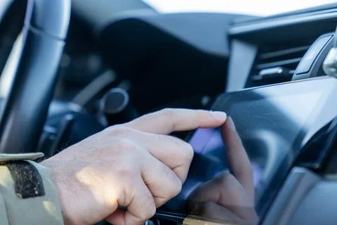 Close-up of driver using touchscreen infotainment system in a modern car Stock Photos