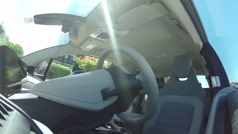 CLOSE UP Driverless self-steering self-parking automatic autonomous electric car Stock Footage