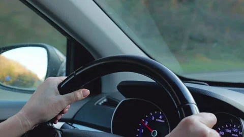 Close-up of the driver's female hands holding the steering wheel Stock Footage 305750639