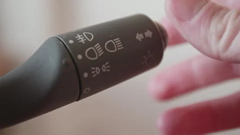 Close-up of a driver's hand operating a car light switch stalk Vídeo Stock 325222832