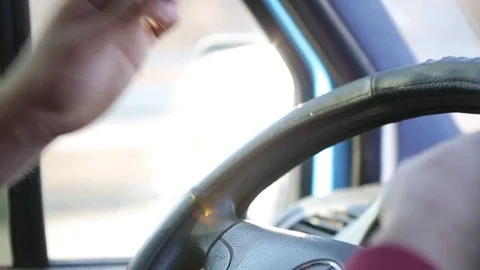 Close-up of a driver's hand on the steering wheel of a car while driving at suns Stock Footage 71983347