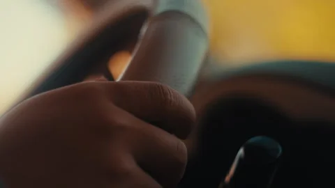 Close-up of Driver's Hand on Steering Wheel Stockbeeldmateriaal 331414326
