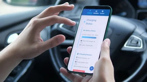 Close-up of a drivers hands in a car using a dedicated mobile application to Stock Footage 315210596