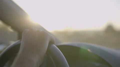 Close up Of  Driver's Hands On Steering Wheel at sunset drive. Stock Footage 96208069