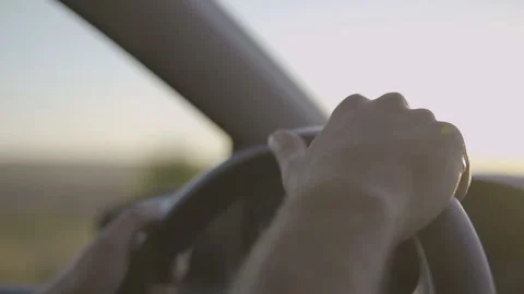 Close up Of  Driver's Hands On Steering Wheel at sunset drive. Stock Footage 96208285