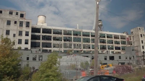 CLOSE UP Driving past the construction site at the abandoned Fisher car factory Stock Footage 77070971