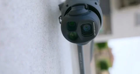 Close-up of a drone camera and gimbal resting near a textured wall, showcasing Stock Footage 345021907