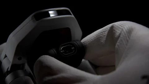 Close-Up of Drone Camera in Gloved Hand Against Black Background Stock Footage 276297637