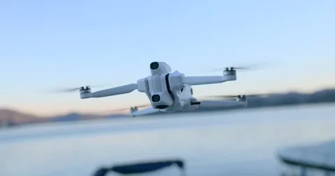 Close Up of Drone Hovering over Lake Water at Sunset Stock Footage 343928262
