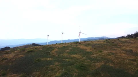 Close drone pass beside mountain wind turbine Stock Footage 322791633