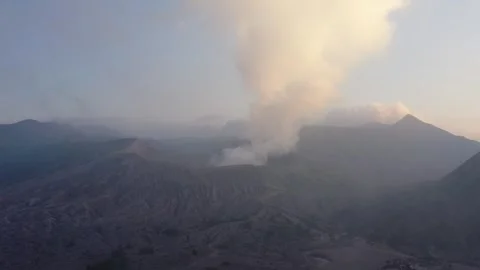 Close-up drone push toward smoking Mount Bromo crater at sunrise Stock Footage 338099357