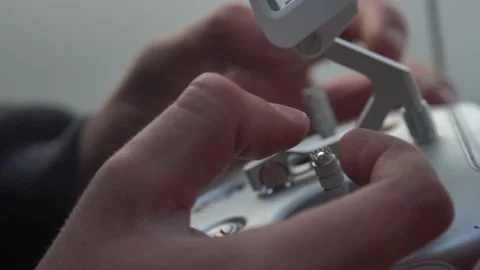  close-up. drone remote control in hand. the phone shows the signal  Video stock 142825099