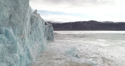 Close up of drone shot of ice surfacing after glacier calving event on Svalbard. Stock Footage 265798070