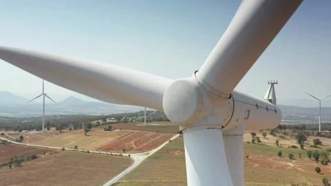 Close up drone shot of a spinning wind turbine in a rural wind farm Stock Footage 335952537