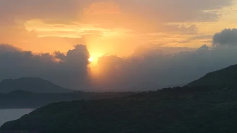 Close up drone shot of sunset setting behind clouds 4K25 動画素材 332893306