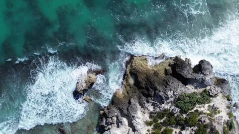 Close-up drone shot of waves crashing against the cliffs of Isla Mujeres, Mexico Stock Footage 331519663