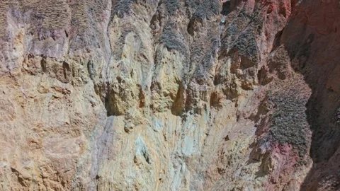 Close-Up Drone of Vibrant Red and Orange Clay Formations at Base of Colca Stock Footage 325317579
